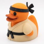 Karate Duck Collectible Figurine - Vibrant Orange Martial Arts Desk Decor for Unique Gift or Shelf Display - 3D Printed in Canada