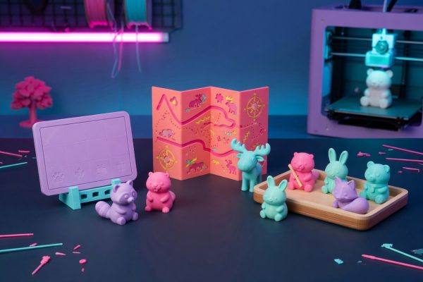 Kawaii 3D-printed figurines in synthwave neon on a Quebec maker bench